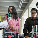  Group of ninth graders assembling robots