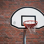 basketball hoop against a brick wall